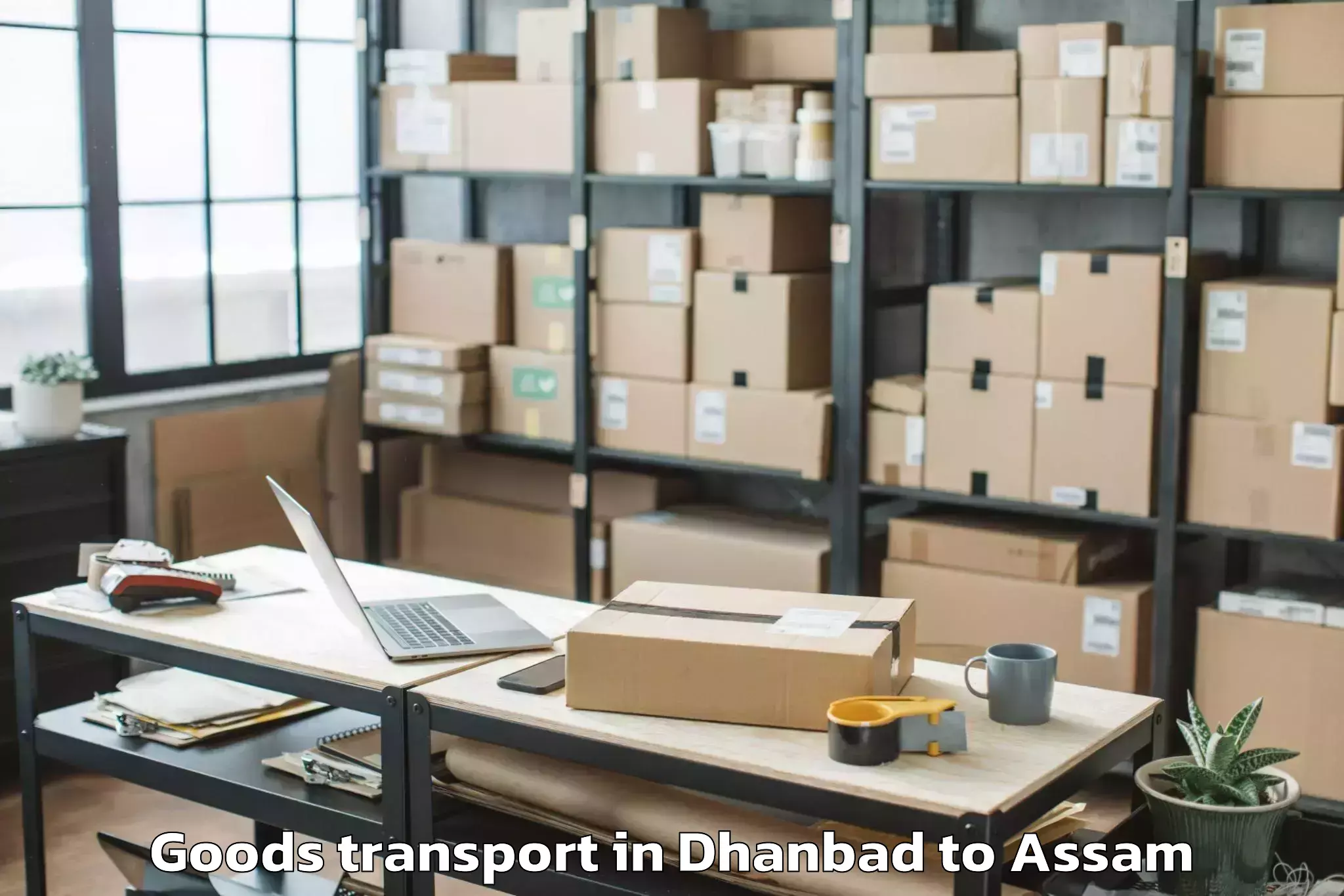 Book Dhanbad to Golokganj Pt Goods Transport Online